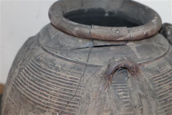 An Egyptian terracotta jar, with four carrying lug handles, Pre-Dynastic, H. 35cm, badly cracked